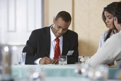 Businessman writing on document
